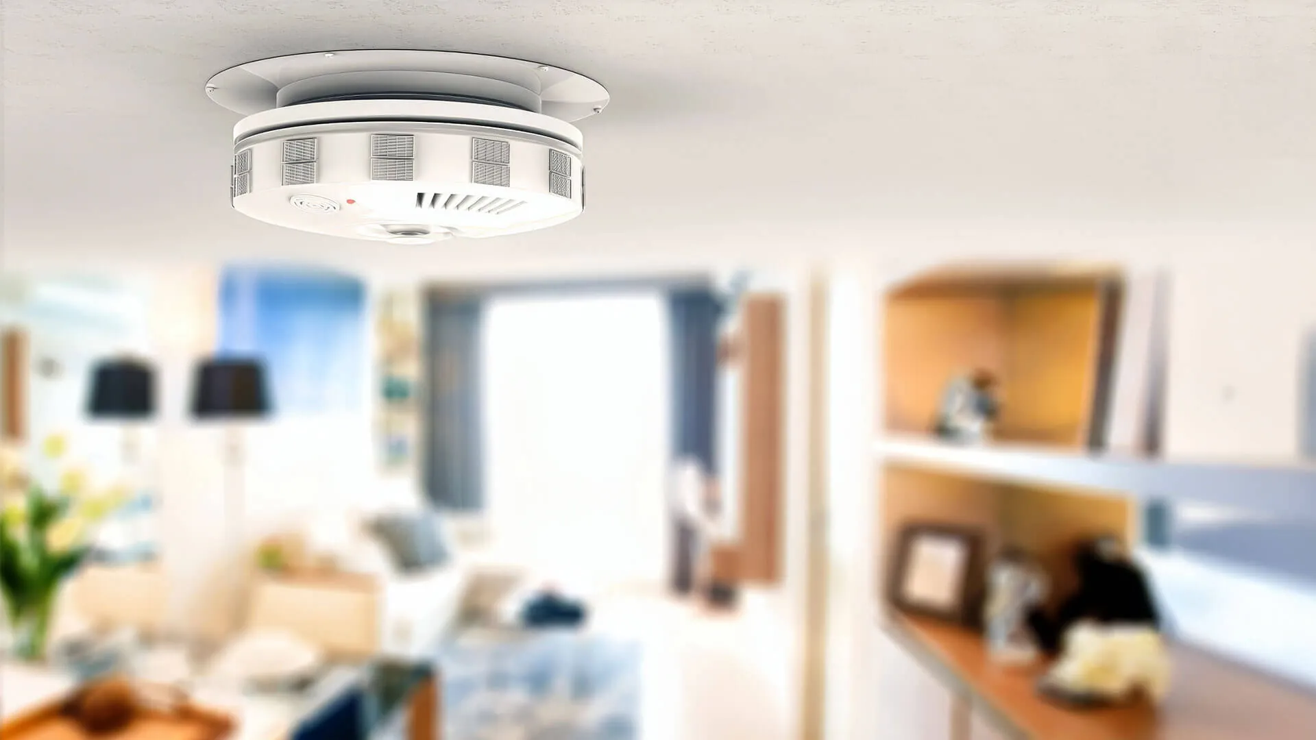 Licensed electrician installing interconnected photoelectric smoke alarm