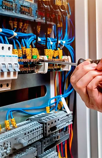 Electrician connecting circuits to a new switchboard